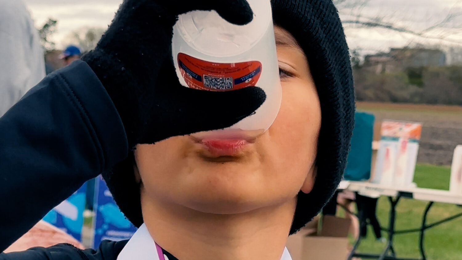 A young runner drinks from a reusable cup. Photo by Craig Conoley/EnviroCentre
